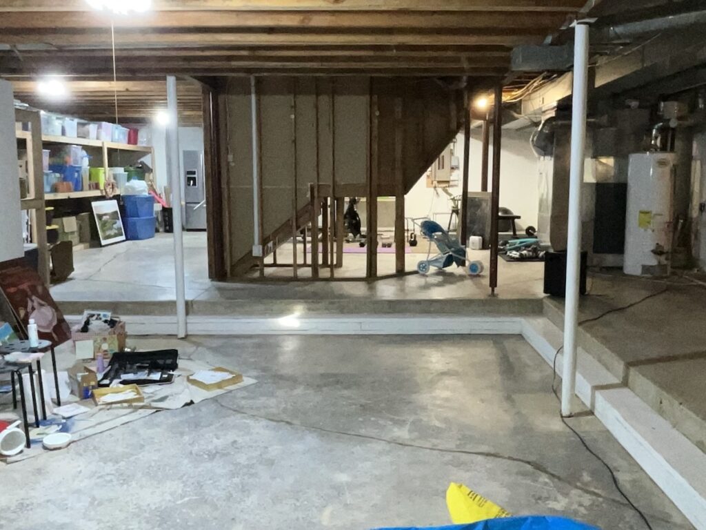an area of an unfinished basement with a sunken floor before construction begins on basement remodeling in Leawood